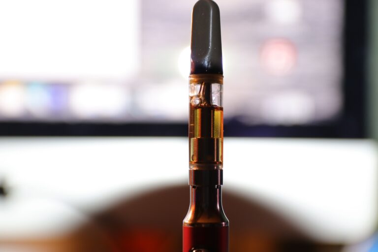 Vape pen cartridge full of distillate oil.
